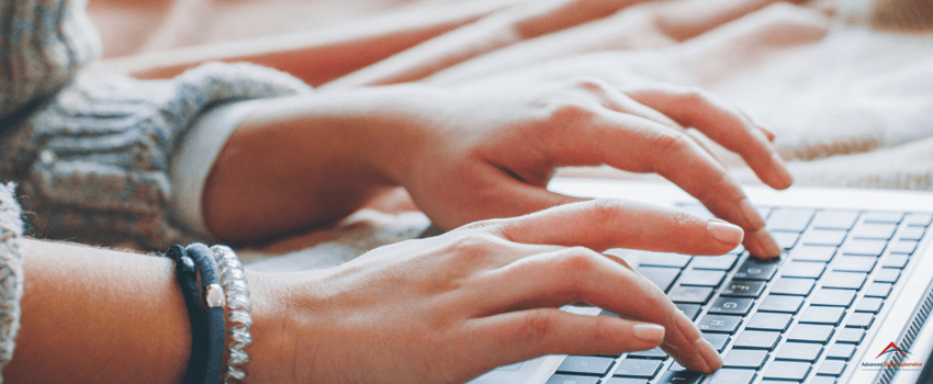 A hand typing on a keyboard. Content writer typing.