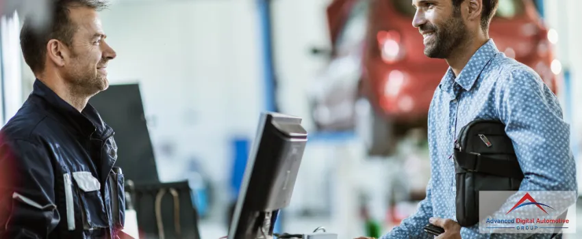 ADAG - A customer happily talking to a mechanic in an auto repair shop